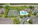 Aerial view showcases pool, tennis court and community amenities, surrounded by lush landscaping at 1979 Summer Club Dr # 111, Oviedo, FL 32765