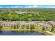 An aerial shot showcasing the apartment complex and its scenic waterfront location with lush greenery at 1979 Summer Club Dr # 111, Oviedo, FL 32765