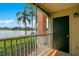 Screened balcony view overlooking lush greenery and a scenic lake at 1979 Summer Club Dr # 111, Oviedo, FL 32765