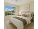 Comfortable bedroom with ample natural light and a serene view from the large window at 1979 Summer Club Dr # 111, Oviedo, FL 32765