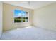 Bright bedroom featuring a large window with views of lush greenery and plenty of natural light at 1979 Summer Club Dr # 111, Oviedo, FL 32765