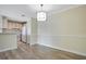 Open-concept dining area with updated flooring adjacent to the kitchen at 1979 Summer Club Dr # 111, Oviedo, FL 32765