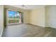 Bright living room featuring wood-look flooring and sliding glass doors leading to a balcony at 1979 Summer Club Dr # 111, Oviedo, FL 32765