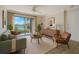Comfortable living room with water views from the balcony and neutral tones at 1979 Summer Club Dr # 111, Oviedo, FL 32765