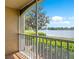 Scenic view from a screened porch overlooking lush greenery and a tranquil lake at 1979 Summer Club Dr # 111, Oviedo, FL 32765