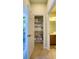Bathroom storage includes towel rack and open door to view backyard pool at 206 Yellow Snapdragon Dr, Davenport, FL 33837