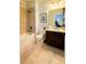 Well-lit bathroom features a tub/shower combo, dark wood vanity, and neutral tones at 206 Yellow Snapdragon Dr, Davenport, FL 33837