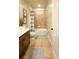 Cozy bathroom featuring tiled shower/tub, vanity with dark cabinets and neutral-toned walls at 206 Yellow Snapdragon Dr, Davenport, FL 33837