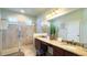 Bathroom features double vanity, granite countertops, and tile shower at 206 Yellow Snapdragon Dr, Davenport, FL 33837