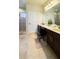 Bright bathroom with double vanity, framed mirror, and separate shower at 206 Yellow Snapdragon Dr, Davenport, FL 33837