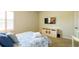 Comfortable bedroom with blue bedding, TV, dresser, and ample natural light from the shuttered window at 206 Yellow Snapdragon Dr, Davenport, FL 33837