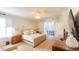 This bedroom features a ceiling fan, a dresser, and a door to the porch at 206 Yellow Snapdragon Dr, Davenport, FL 33837