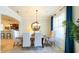 Formal dining area featuring a wooden table, seating for six, and large picturesque window at 206 Yellow Snapdragon Dr, Davenport, FL 33837
