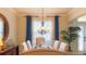 Elegant dining room featuring a chandelier, plantation shutters, and stylish decor with plenty of light at 206 Yellow Snapdragon Dr, Davenport, FL 33837