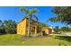 Two story home featuring attached garage, manicured lawn and landscaping at 206 Yellow Snapdragon Dr, Davenport, FL 33837