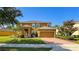 Charming two-story home with a well-manicured lawn and inviting brick driveway at 206 Yellow Snapdragon Dr, Davenport, FL 33837