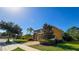 Two-story home featuring a well-manicured lawn, paved driveway, and mature landscaping on a sunny day at 206 Yellow Snapdragon Dr, Davenport, FL 33837