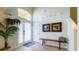 Bright foyer with soaring ceilings, decorative art, bench, and tile flooring at 206 Yellow Snapdragon Dr, Davenport, FL 33837