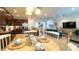Open concept kitchen with stainless steel appliances and a dining table, flowing into the living area at 206 Yellow Snapdragon Dr, Davenport, FL 33837