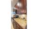 This kitchen features dark wood cabinets, granite countertops, and stainless steel appliances at 206 Yellow Snapdragon Dr, Davenport, FL 33837