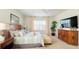 Bright main bedroom featuring a ceiling fan, carpet, and ample natural light at 206 Yellow Snapdragon Dr, Davenport, FL 33837