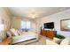 This bedroom features a ceiling fan, a dresser, and a door to the porch at 206 Yellow Snapdragon Dr, Davenport, FL 33837