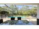 Screened-in pool and patio area surrounded by lush landscaping, and outdoor seating at 206 Yellow Snapdragon Dr, Davenport, FL 33837