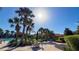 Community pool with sun loungers, tables and tropical landscaping at 206 Yellow Snapdragon Dr, Davenport, FL 33837