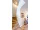 Carpeted stairs with white railing leads to the upper level, complemented by decorative wall art at 206 Yellow Snapdragon Dr, Davenport, FL 33837