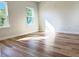 Bright bedroom featuring wood-look floors and two windows overlooking the outdoors at 2336 Sw 168Th Loop, Ocala, FL 34473