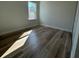 This bedroom boasts bright light from a large window and beautiful hardwood floors at 2336 Sw 168Th Loop, Ocala, FL 34473
