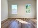 Bright bedroom featuring wood-look flooring and dual windows offering natural light at 2336 Sw 168Th Loop, Ocala, FL 34473