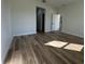 Spacious bedroom featuring wood-look flooring and an open doorway at 2336 Sw 168Th Loop, Ocala, FL 34473