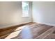 Neutral bedroom with a large window allowing natural light and wood-look flooring at 2336 Sw 168Th Loop, Ocala, FL 34473