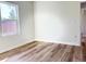 This bedroom boasts bright light from a large window and beautiful hardwood floors at 2336 Sw 168Th Loop, Ocala, FL 34473