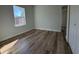 This bedroom boasts bright light from a large window and beautiful hardwood floors at 2336 Sw 168Th Loop, Ocala, FL 34473