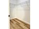 Walk-in closet with wood-look flooring and wire shelving installed at 2336 Sw 168Th Loop, Ocala, FL 34473