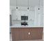Kitchen island with wood trim and white countertops, pendant lighting, and stainless appliances at 2336 Sw 168Th Loop, Ocala, FL 34473