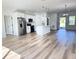 Bright, open kitchen with center island, stainless appliances, and wood-look flooring throughout the open floor plan at 2336 Sw 168Th Loop, Ocala, FL 34473
