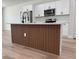 Kitchen island with wood trim, white cabinets, and stainless steel appliances at 2336 Sw 168Th Loop, Ocala, FL 34473