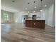 Modern open kitchen features sleek wooden-paneled island, stainless appliances, and ample counter space at 2336 Sw 168Th Loop, Ocala, FL 34473