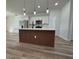 Modern open kitchen features sleek wooden-paneled island, stainless appliances, and ample counter space at 2336 Sw 168Th Loop, Ocala, FL 34473