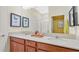 Bright bathroom with double vanity, granite countertops, and framed butterfly prints at 2345 White Buffalo St, Apopka, FL 32703