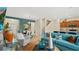 Open-concept living room featuring modern furnishings, wood-look floors, stylish decor, and views to the dining room and kitchen at 2345 White Buffalo St, Apopka, FL 32703