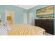 Stylish main bedroom with panelled teal walls, neutral decor, and an en-suite bathroom at 2345 White Buffalo St, Apopka, FL 32703