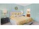 Stylish main bedroom with teal walls, gold accents, and en-suite bathroom access at 2345 White Buffalo St, Apopka, FL 32703