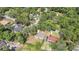 An aerial view of a property surrounded by mature trees and lush greenery in a residential neighborhood at 2536 Nw 3Rd Ave, Ocala, FL 34475