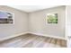 Bright bedroom featuring wood-look floors and two windows providing natural light at 2536 Nw 3Rd Ave, Ocala, FL 34475