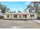 A single story house with a white exterior, light colored front porch, and fenced yard at 2536 Nw 3Rd Ave, Ocala, FL 34475