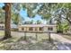 Charming single-story home featuring a fenced yard and neutral exterior paint with natural wood columns on the front porch at 2536 Nw 3Rd Ave, Ocala, FL 34475